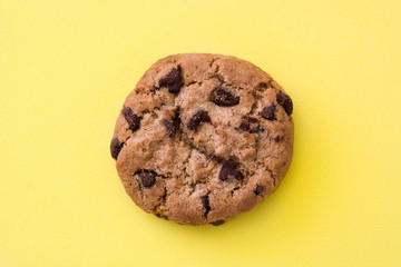 Chocolate chip cookie on yellow background
