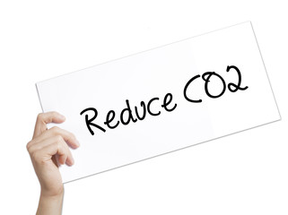 Reduce CO2 Sign on white paper. Man Hand Holding Paper with text. Isolated on white background.