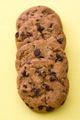 Chocolate chip cookies on yellow background

