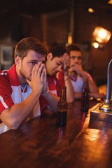 Group of male friends watching football match