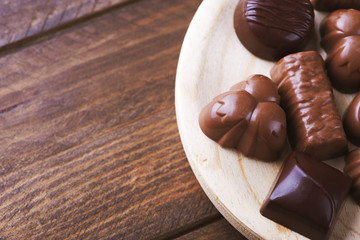 Candies in wooden bowl. Horizontal shoot.