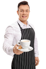 Young waiter offering a cup of coffee