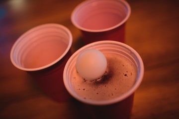 Close-up of pong ball on beer glass 