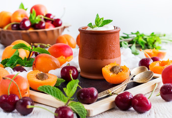 Fresh yogurt with organic ripe apricots and cherries