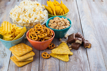 Unhealthy snacks on wooden background