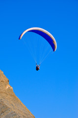 paraglider in the air over the mountains