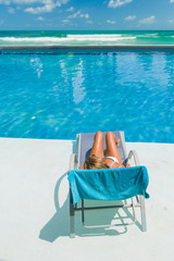 Fototapeta na wymiar Relaxing woman in luxury hotel pool on holidays vacation