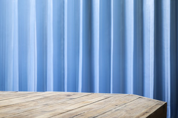 Empty table top with office blue blinds for montage your product or ads.