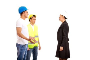 Female engineer talking with two builders