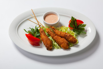 Fried shrimp with salad on white dish