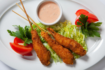 Fried shrimp with salad on white dish