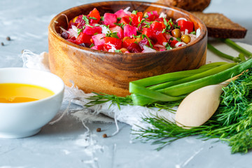 Russian Ukrainian traditional beetroot salad vinaigrette with bread, oil and greens. Love for a healthy vegan food concept