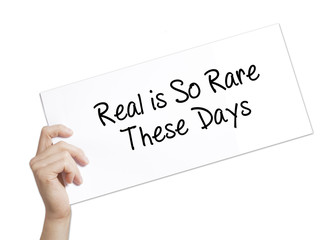 Real is So Rare These Days Sign on white paper. Man Hand Holding Paper with text. Isolated on white background.