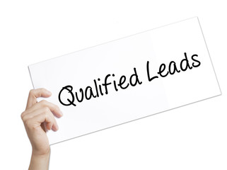 Qualified Leads Sign on white paper. Man Hand Holding Paper with text. Isolated on white background
