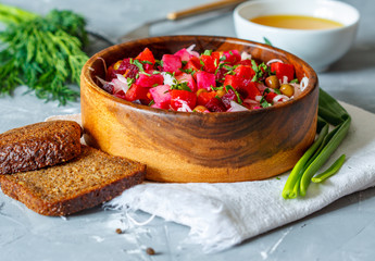 Russian Ukrainian traditional beetroot salad vinaigrette with bread, oil and greens. Love for a healthy vegan food concept