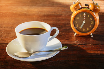 Coffee mug and book on old wooden table