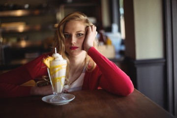Portrait of beautiful woman having milkshake