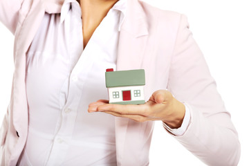 Business woman holding a house model
