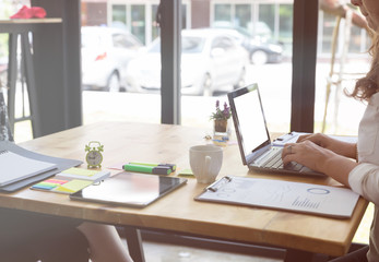 Businesswoman typing on laptop at workplace. Woman working in home office. hand on keyboard