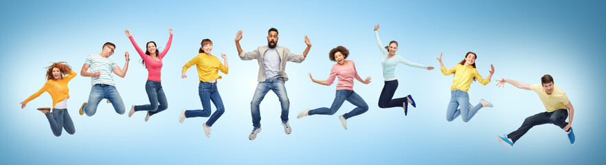 happy people or friends jumping in air over blue