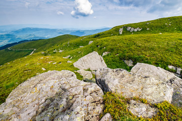 meadow with boulders in Carpathian mountains in summer