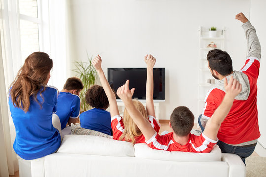 friends or football fans watching tv at home