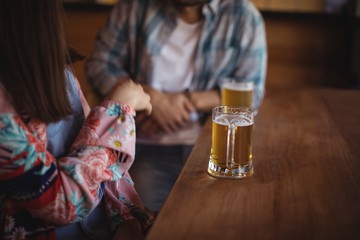 Couple having beer at counter