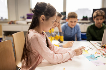 happy kids with invention kit at robotics school