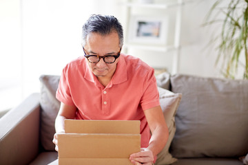 man opening parcel box at home