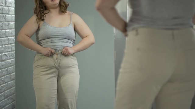 Fat girl having problems with getting into her favorite pants, overeating result