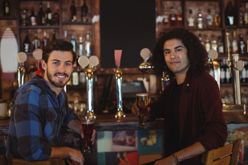 Friends having beer at bar counter