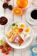 Breakfast with boiled egg, ham and cheese