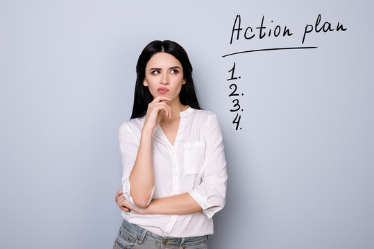 Portrait Of Cute Young  Woman With Pouted Sensual Lips And Black Hair Fink About New Idea And Looking At Drawn List Of Action Plan. Copy Space On Item