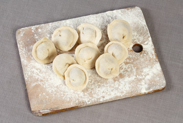 Homemade meat dumplings, raw tortellini and ravioli on the table