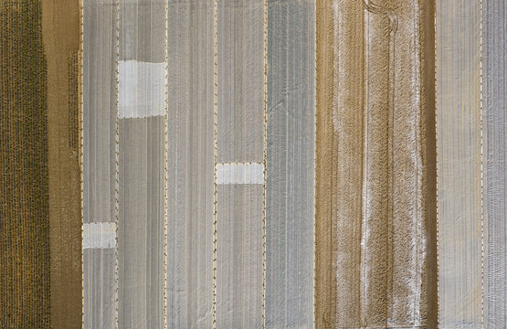 Distant view of agricultural fields covered with plastic