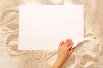 Child's hand turning over paper