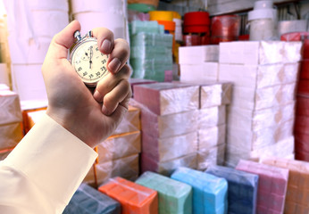 Paper products storehouse and stopwatch in hand
