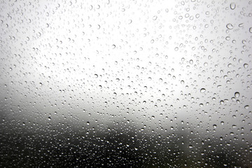 Falling raindrops on glass