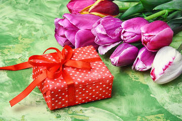 Bouquet of purple tulips and gift box