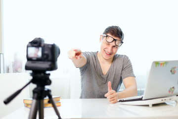 Young male blogger recording video at home