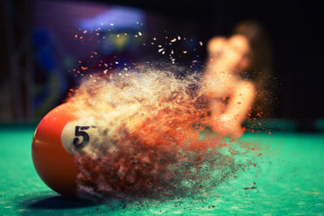 Orange billiard ball splits into particles and debris upon impact - obrazy, fototapety, plakaty
