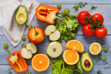 Pattern of fresh vegetables on blue wood background with copy space