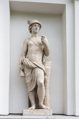 Mercury - God is the patron of trade. Statue of Pudozh stone in the niche of the Kitchen Corps of the Elagin Island Palace and Park Complex in St. Petersburg