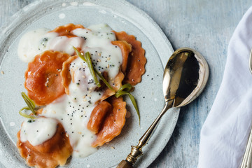 Carrot  pasta stuffed with cheese and vegetables, with béchamel sauce