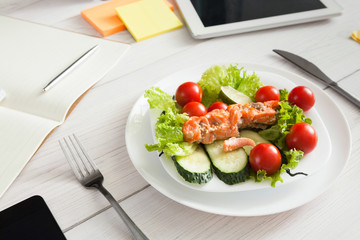 Healthy business lunch snack in office, salmon with vegetables