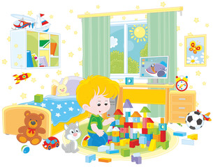 Little boy playing with bricks in his room