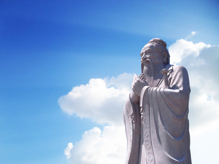Confucius statue with sky background - obrazy, fototapety, plakaty