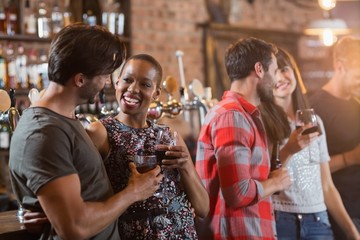 Happy couples holding drinks