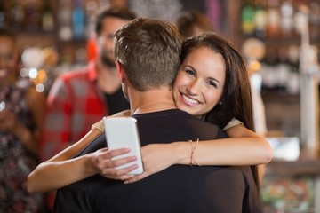 Smiling woman hugging her boyfriend