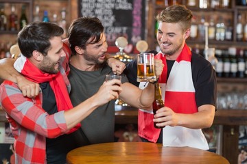 Happy friends enjoying in pub
